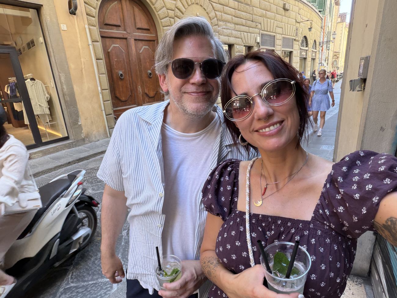 Danielle and Patrick with drinks on a street in Florence