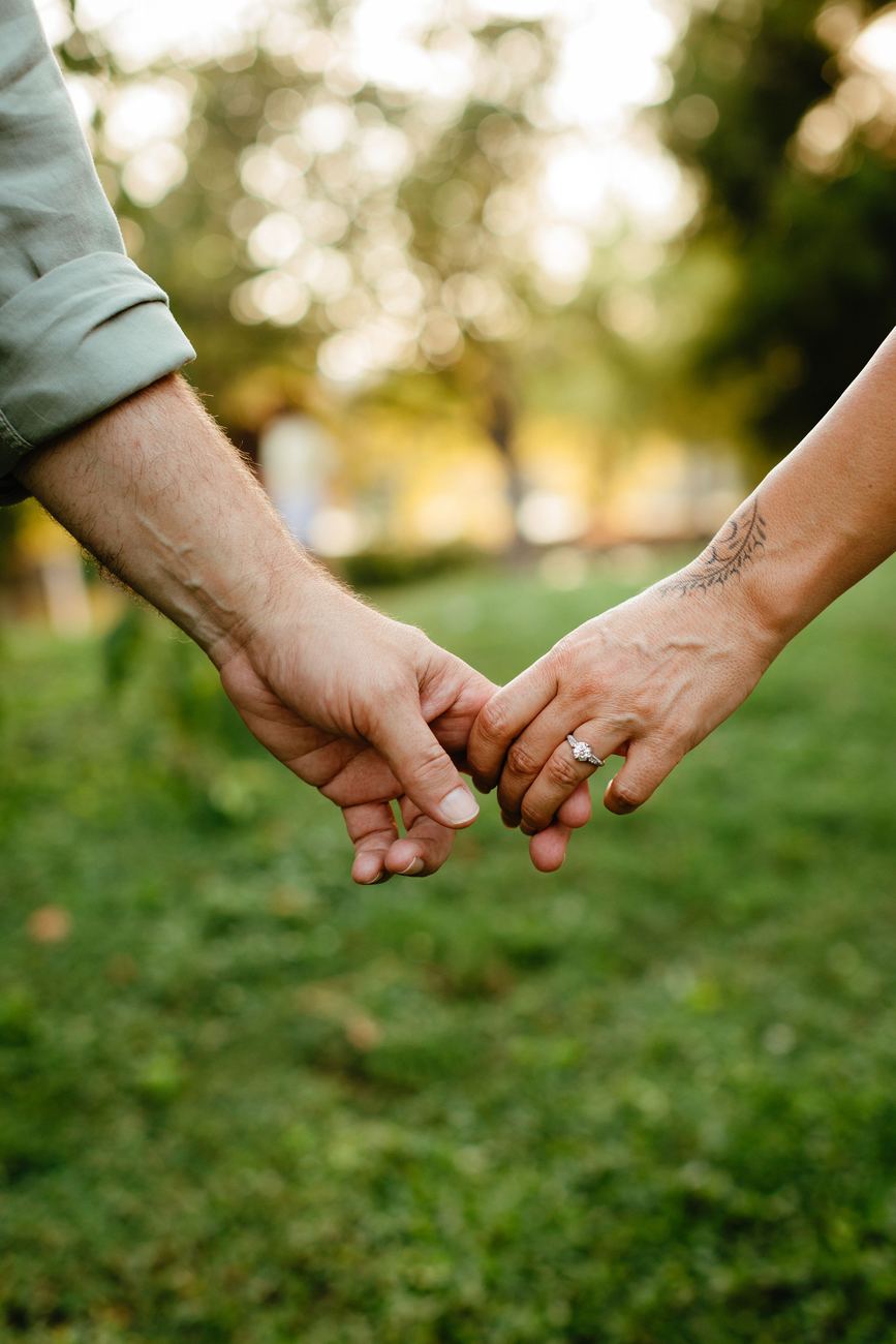 Close-up of Danielle and Patrick holding hands, her engagement ring visible