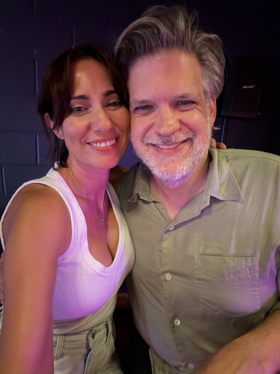 Close selfie of Danielle and Patrick smiling under colorful lights in Nashville
